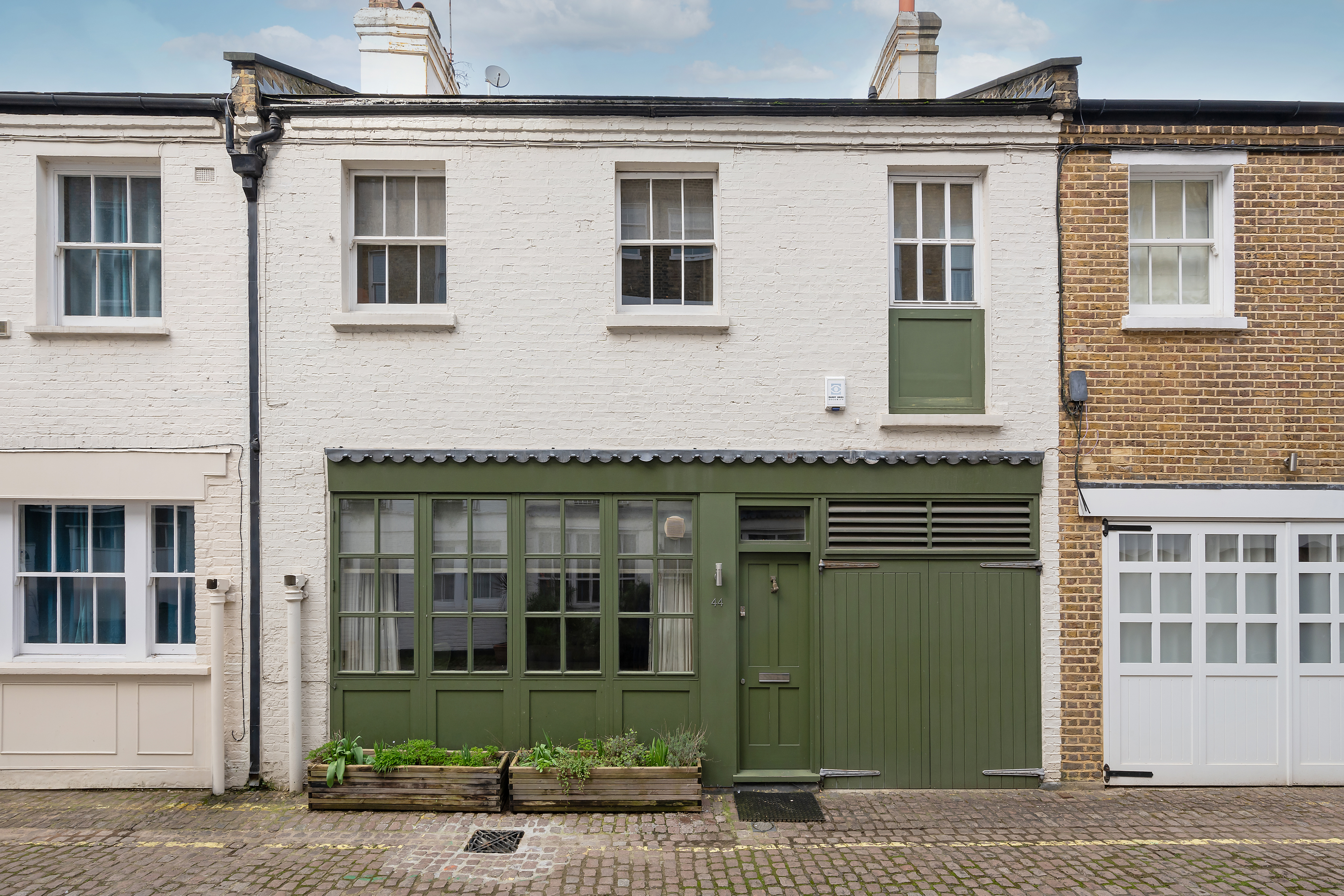 This mews property for sale in London is situated on a gorgeous street