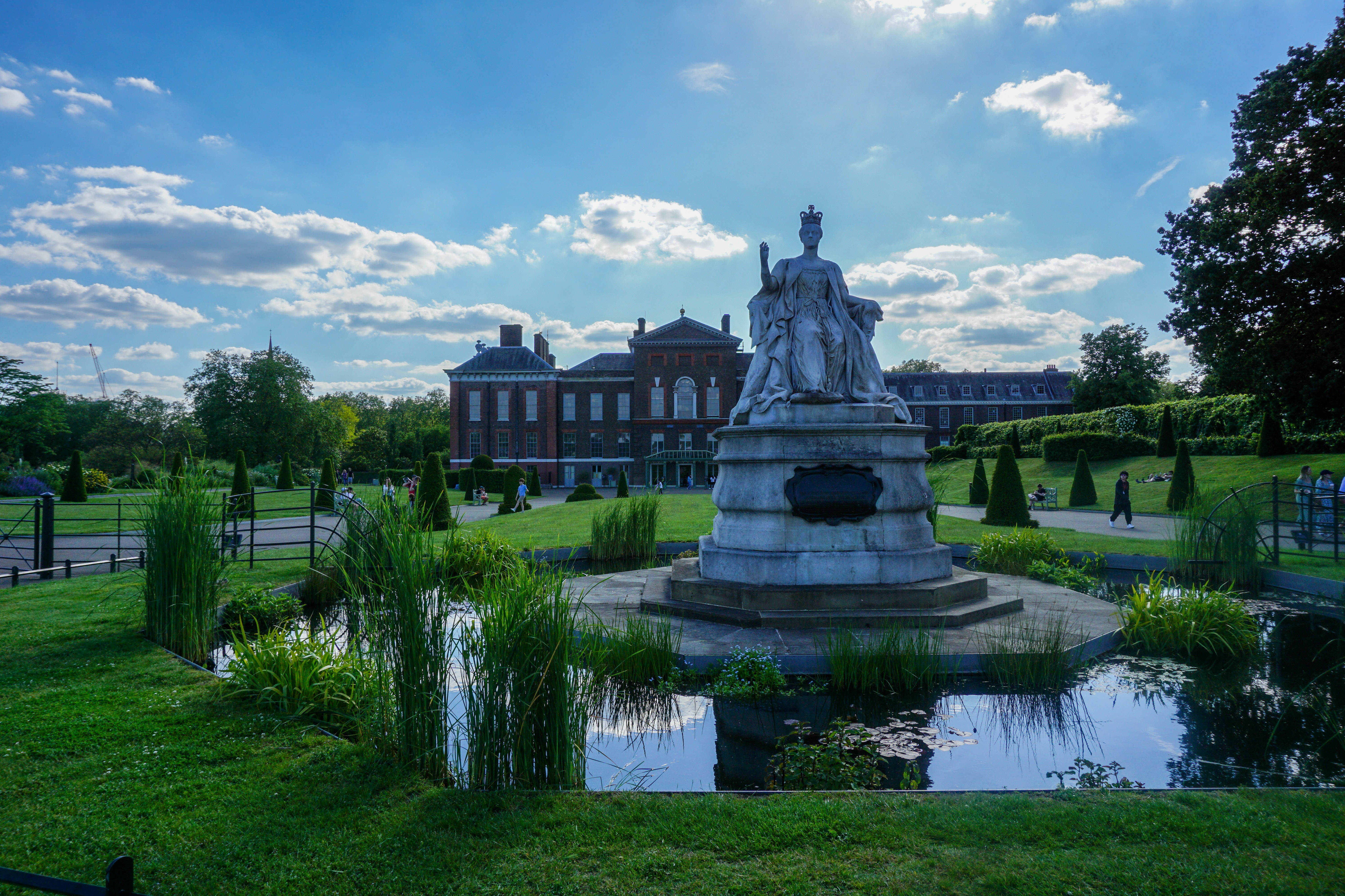 Kensington Palace Is Located In Kensington Gardens, And There Is A Statue Of Queen Victoria Overlooking The Park